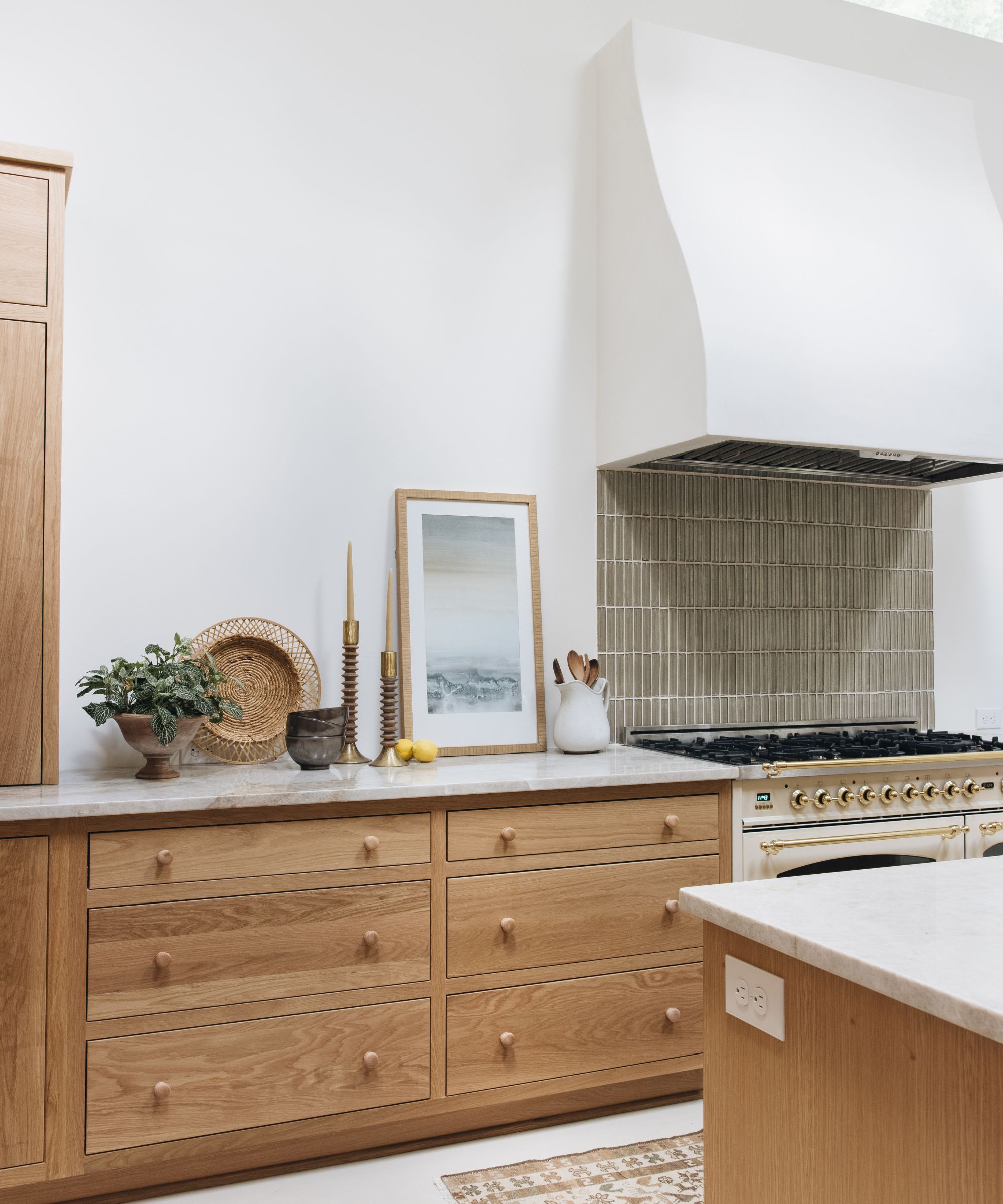 A wood and white kitchen with collected countertop decor