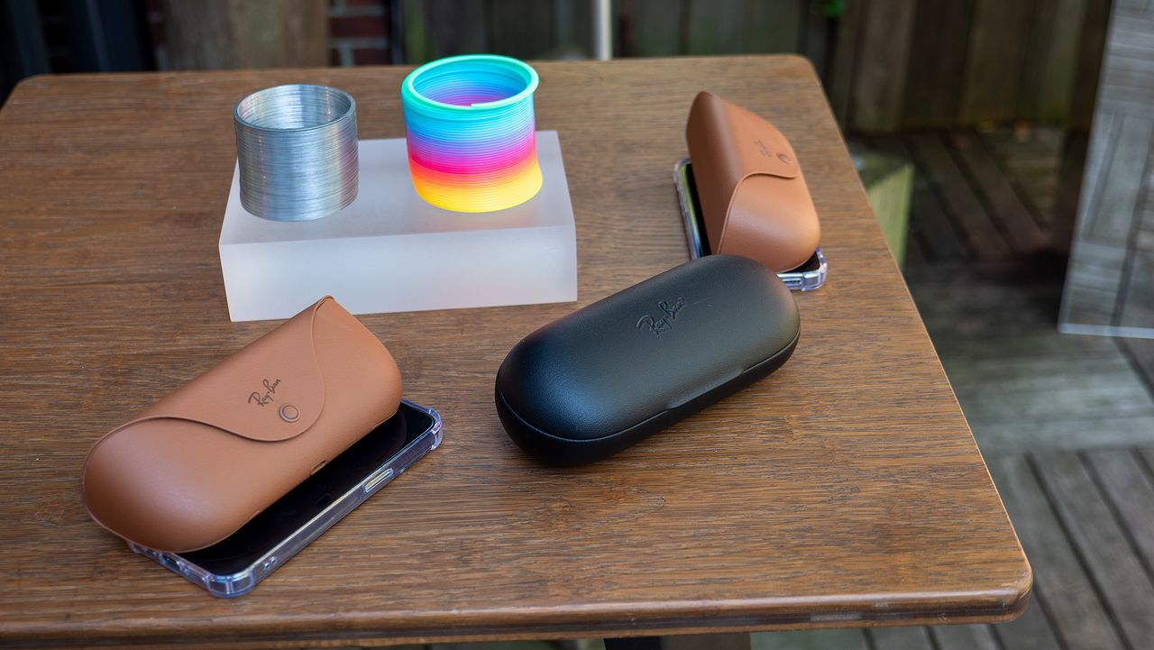Comparing Ray-Ban Meta smart glasses in the new tan charging case with Ray-Ban Stories in its larger black charging case