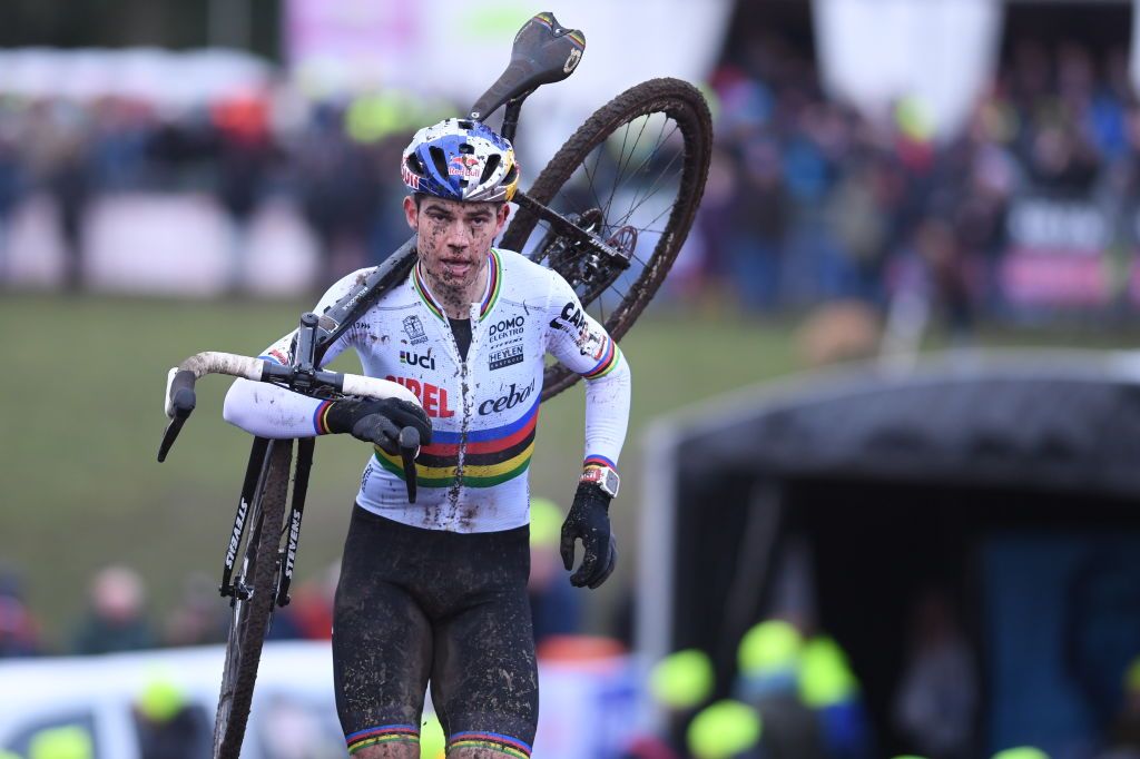 Wout van Aert runs through the mud