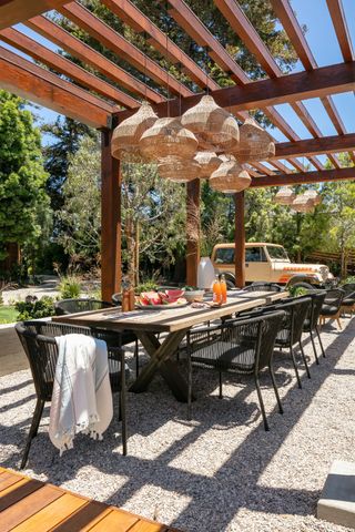 Outdoor dining area with rattan pendants