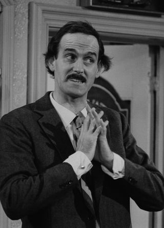 John Cleese as Basil Fawlty.