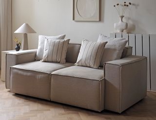 a beige sofa styled with symmetrical pillows