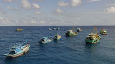 fishing boats joined up on the open ocean