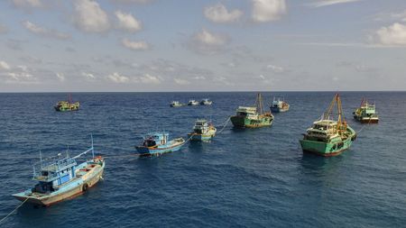 fishing boats joined up on the open ocean