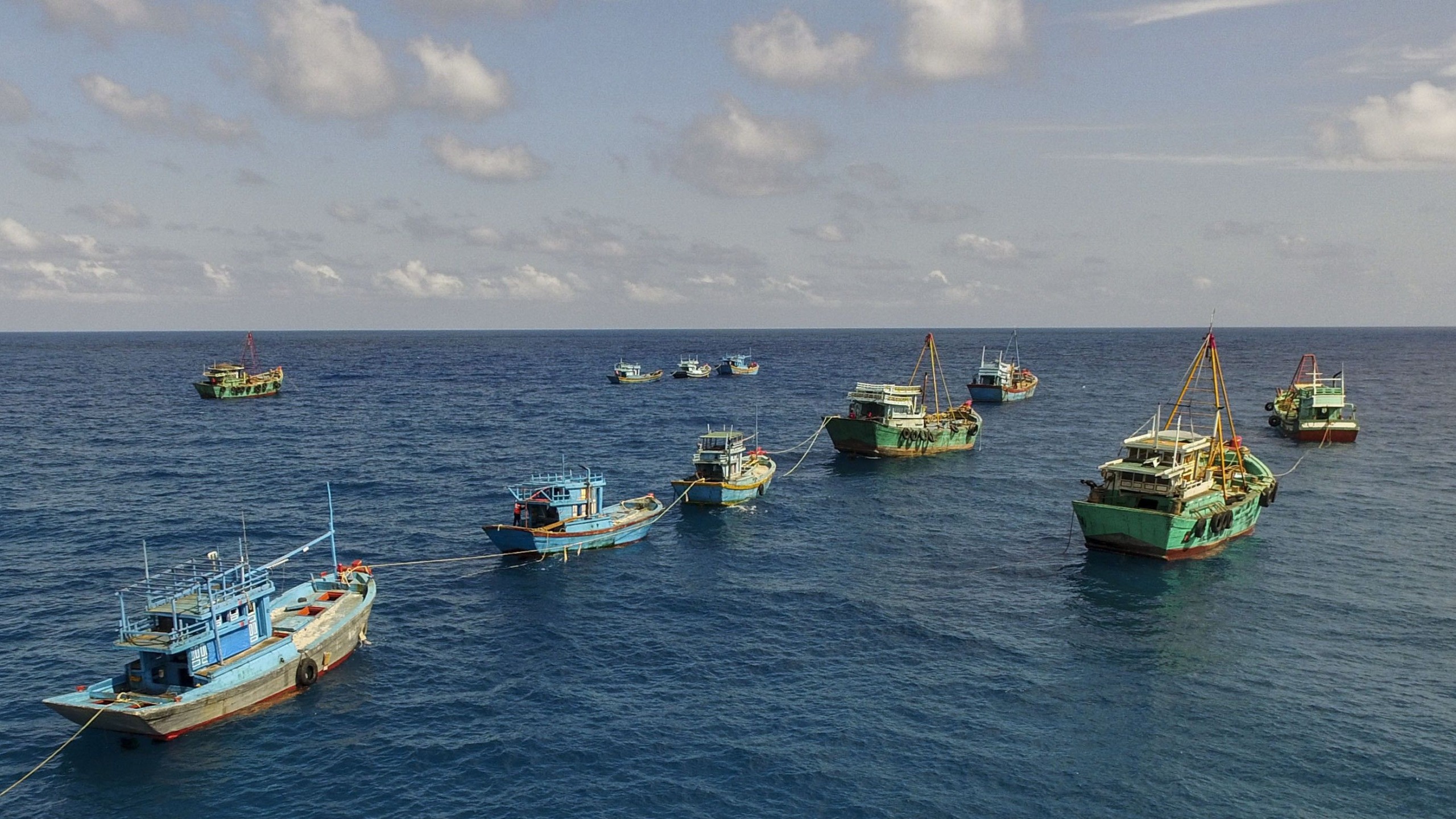 fishing boats joined up on the open ocean