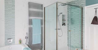 White and sky blue bathroom with glass shower screens to show what you can clean with malt vinegar