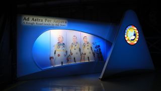 The entrance to the tribute to Apollo 1 shows the three astronauts who perished in a fire at the launch pad on Jan. 27, 1967, during training for the mission. The astronauts are, from left, Gus Grissom, Ed White II and Roger Chaffee. Above the images of the astonaughts there is test that reads 'Ad Astra Per Aspera' which means 'a rough road leads to the stars.'