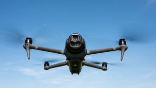 DJI Mavic 4 Pro in flight against a blue sky