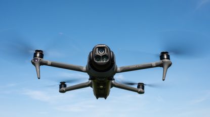 DJI Mavic 4 Pro in flight against a blue sky
