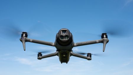 DJI Mavic 4 Pro in flight against a blue sky