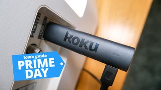 The Roku Streaming Stick 4K plugged into an HDMI port with a Tom's Guide Prime Day Deals graphic