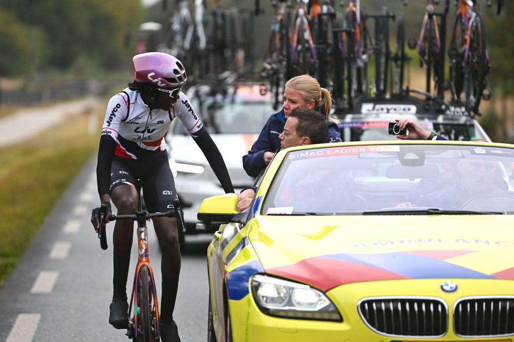 ARNHEM NETHERLANDS OCTOBER 13 Teniel Campbell of Trinidad and Tobago and Team Liv AlUla Jayco assisted by the medical car during the 26th Simac Ladies Tour 2024 Stage 6 a 1458km stage from Arnhem to Arnhem UCIWWT on October 13 2024 in Arnhem Netherlands Photo by Luc ClaessenGetty Images