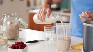 What is bulking? Image shows person pouring milk into smoothie