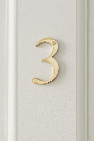 Brass house number on neutral door