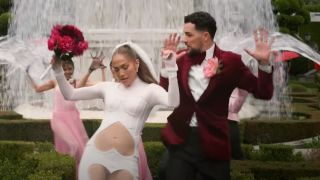Jennifer Lopez dancing in a wedding outfit in the This Is Me...Now trailer.