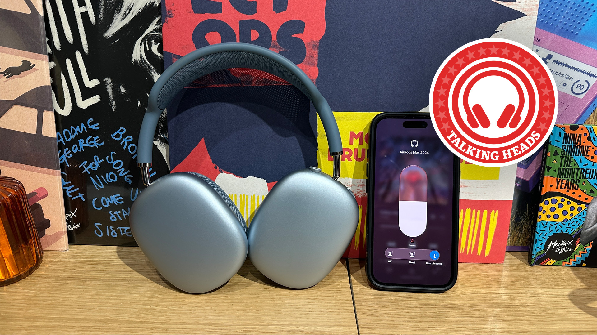 Apple AirPods Max in blue with an iPhone and a WHF Talking Heads roundel