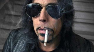 Dave Wyndorf in sunglasses, smoking a cigarette