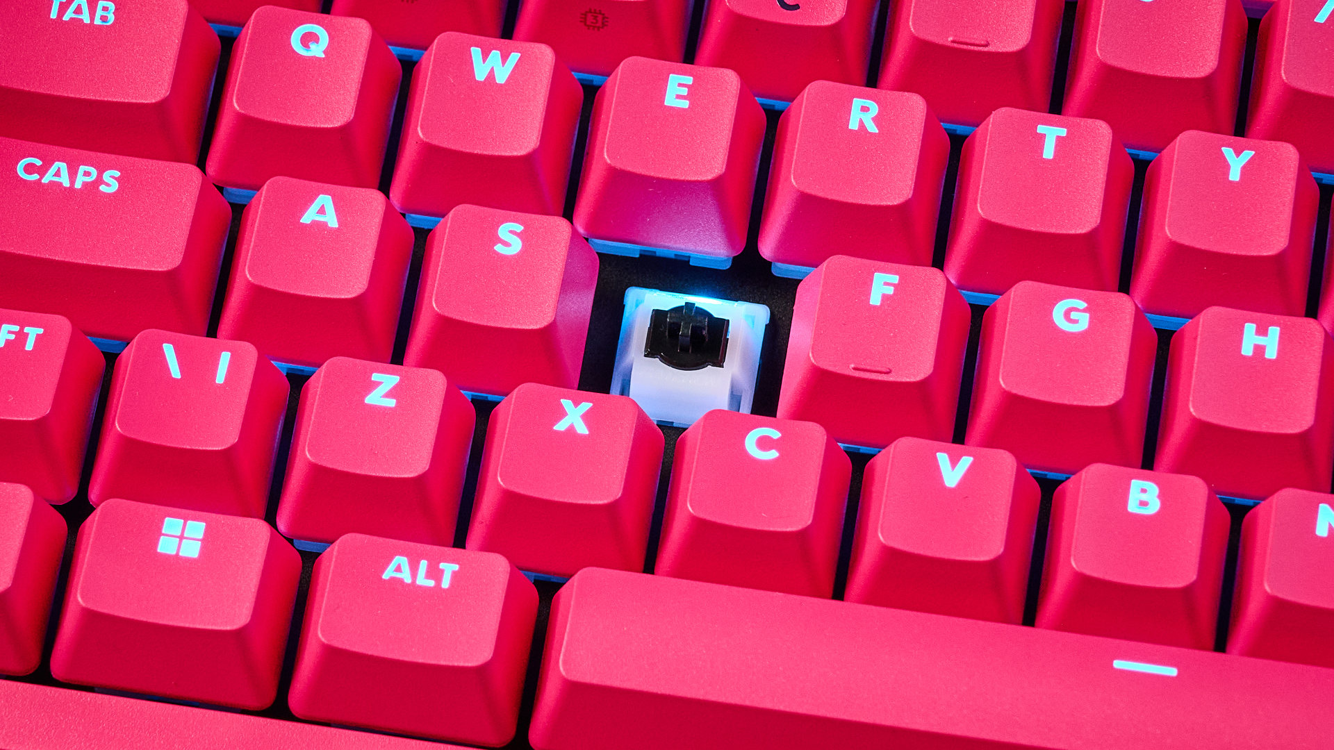 A photo of the Logitech G Pro X2 Rapid keyboard in hot pink on a stone surface