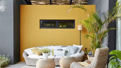 an outdoor feature wall painted in a bold yellow 