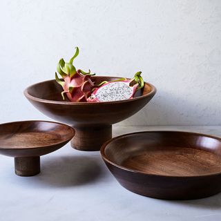 a trio of wooden fruit bowls