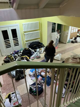 People taking shelter in Kyiv Ukraine with bags of possessions