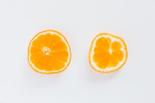 Conceptual image for breasts breast shape breast size womens issues womens health Part of a series Oranges on white background