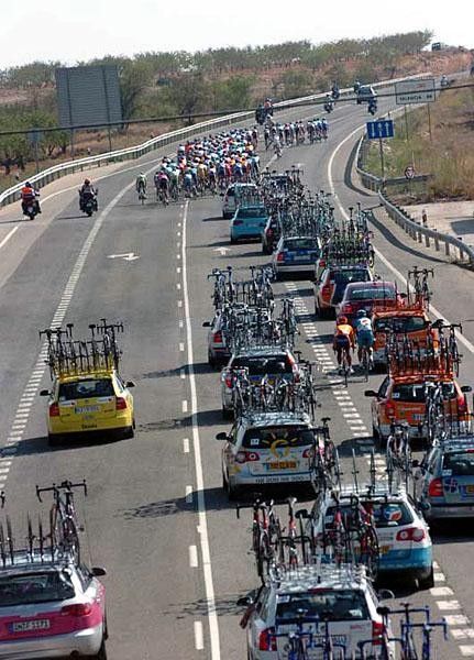 Riders working their way back through the caravan to get into the peloton