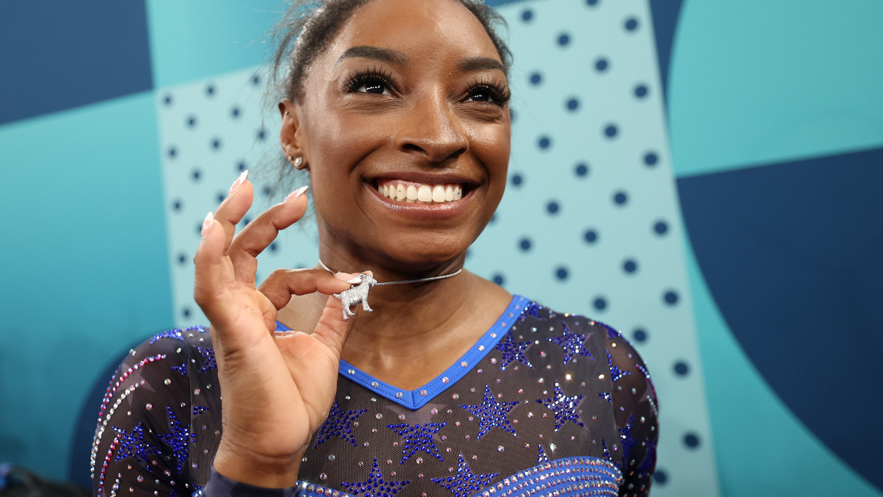 Gold medalist Simone Biles of Team United States poses with a necklace in the likeness of a goat after competing in the Artistic Gymnastics Women&#039;s All-Around Final on day six of the Olympic Games Paris 2024 at Bercy Arena on August 01, 2024 in Paris, France