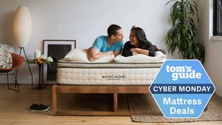 Image shows the Avocado Green Mattress on a wooden bedframe with a Cyber Monday mattress sale badge overlaid on top