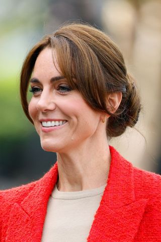 Kate Middleton headshot with a low bun and bangs hairstyle