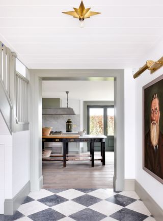 Modern entryway with white walls and pattern floor