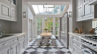 white kitchen orangery extension with black and white chequerboard flooring