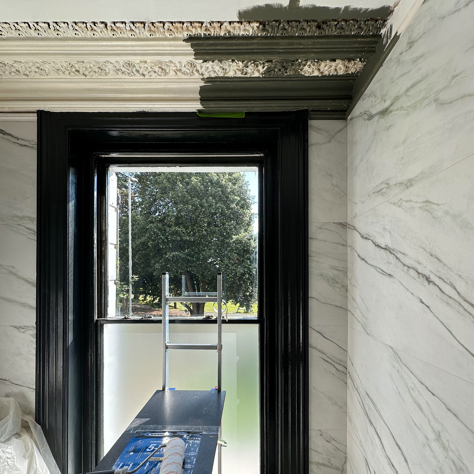 Bathroom ceiling being painted dark green