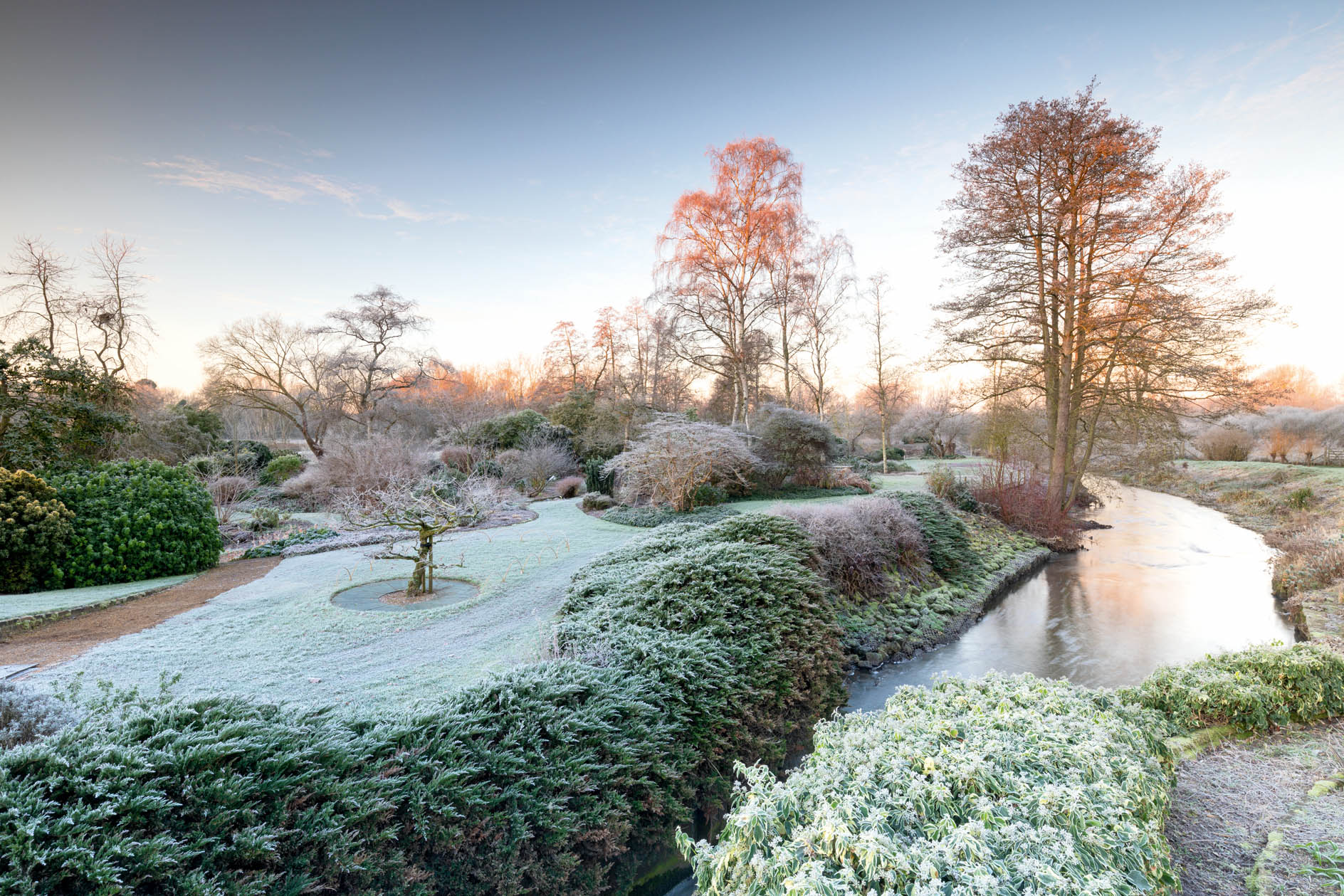 The River Lark winds through the garden, Midland and East of England RHS Partner Garden of the Year 2022. Bernard Tickner used discarded filter plates from the mash tuns at local breweries to protect trees.