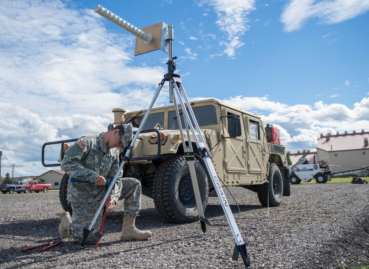 U.S. Army Spc. Angel Mendoza, assigned as a space aggressor operator to the 527th Space Aggressor Squadron, Schriever Air Force Base, Colorado, secures a helical antenna to a gravel pad Aug. 8, 2016, at Eielson Air Force Base, Alaska.