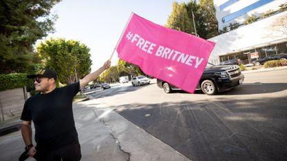 A Britney Spears supporter waves a flag in West Hollywood, California, in 2021.