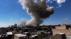 Smoke rises following a bombing run in Tehran, Iran.