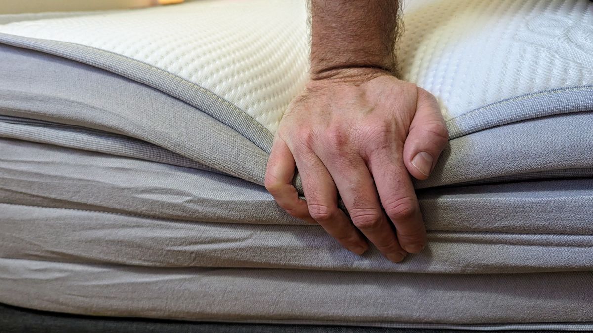 Ecosa Pure mattress showing edge support with hand