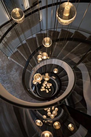 A four storey chandelier hung in the middle of a spiral staircase