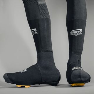 A rider wearing the Spatz Pro Stealth overshoe system