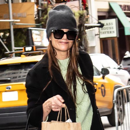 Katie Holmes wearing a beanie and green sweater in NYC