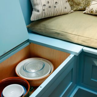 kitchen with storage with sky blue coloured and pillows