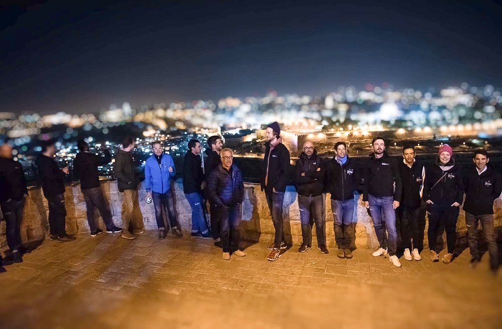 An Israel Cycling Academy team gathering overlooking Jerusalem