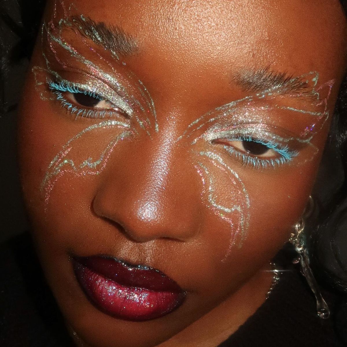 An image of makeup artist Lynda Florae wearing butterfly makeup.
