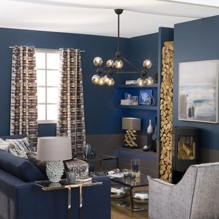 living room with blue walls and wooden flooring