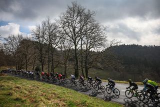 The pack of riders cycles during the 4th stage of the Paris-Nice cycling race, 163,4 km between Vichy and La Loge des Gardes, on March 12, 2025. (Photo by Anne-Christine POUJOULAT / AFP)