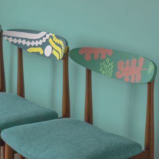 Small back painted chairs with green cushion