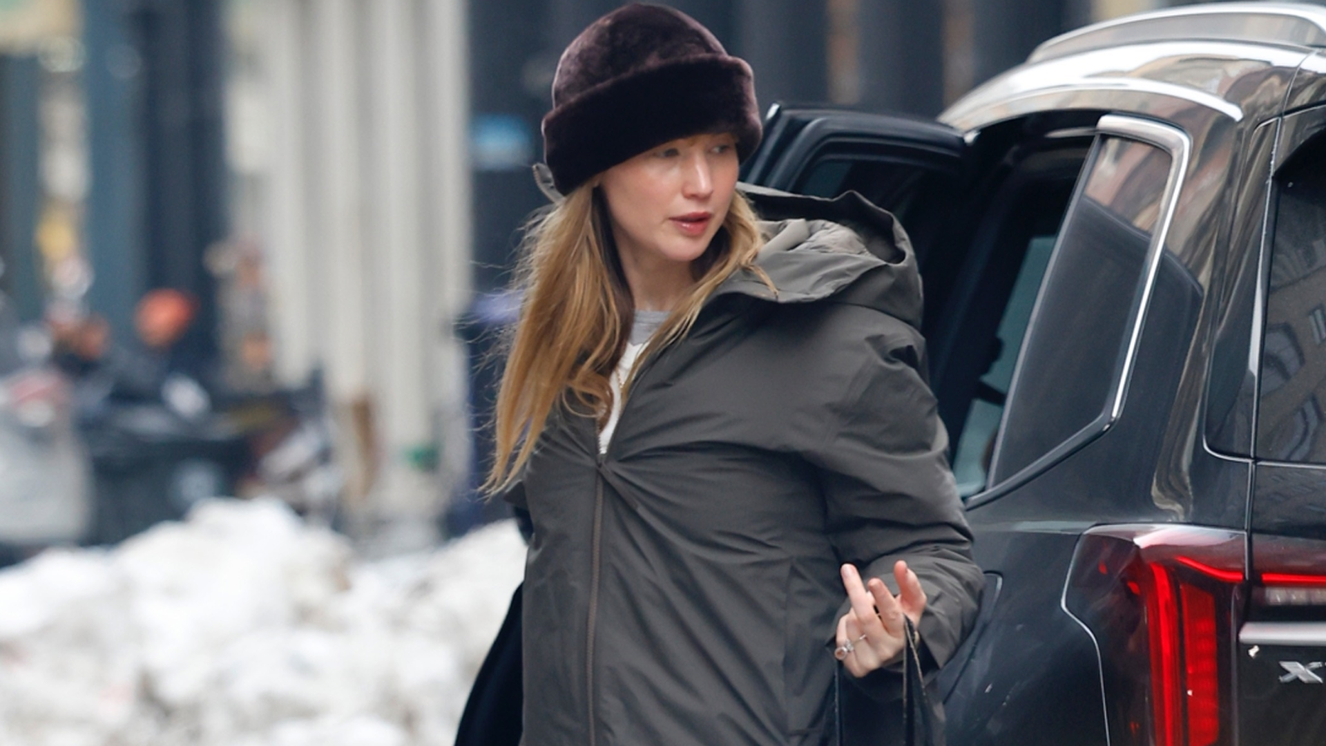 Jennifer Lawrence was spotted in NYC wearing a parka, a fur hat, a vintage Dior Galliano bag, and Ugg boots