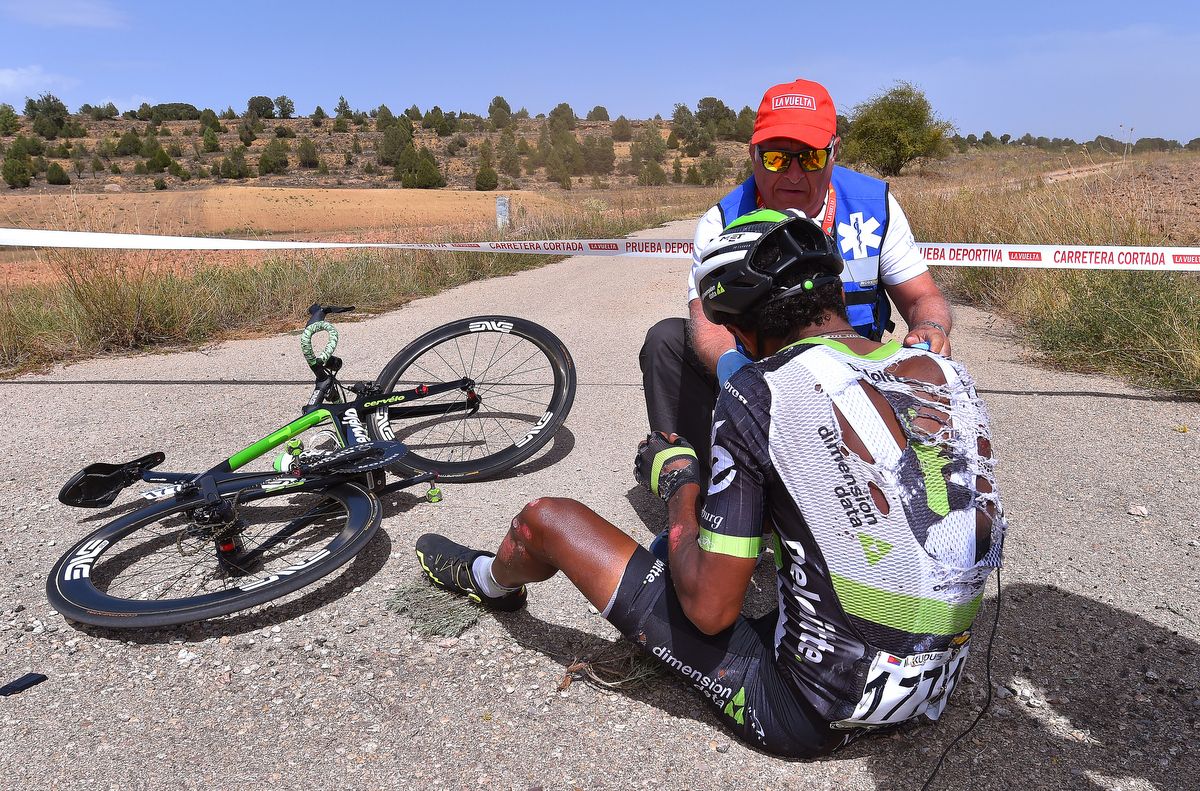 Merhawi Kudus receives assistance after his Vuelta crash