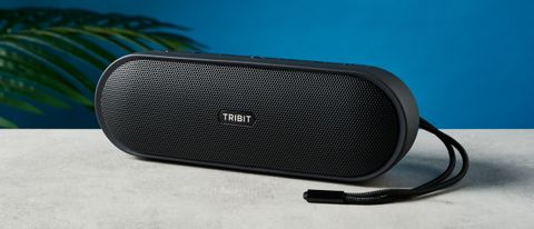 The Tribit XSound Plus 2 on a stone surface against a blue background